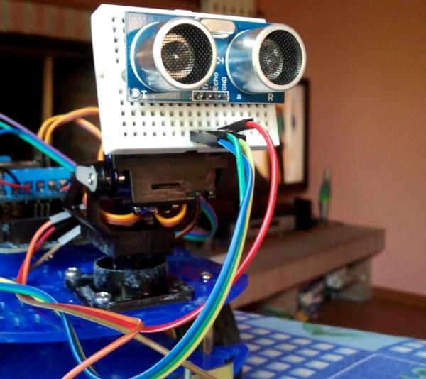 Robot with ultrasonic sensor for measuring distance to obstacles